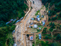 The aerial view shows the flood-affected areas of Patikharka, Kavrepalanchok District, Nepal, on October 3, 2024. Homes are severely damaged...