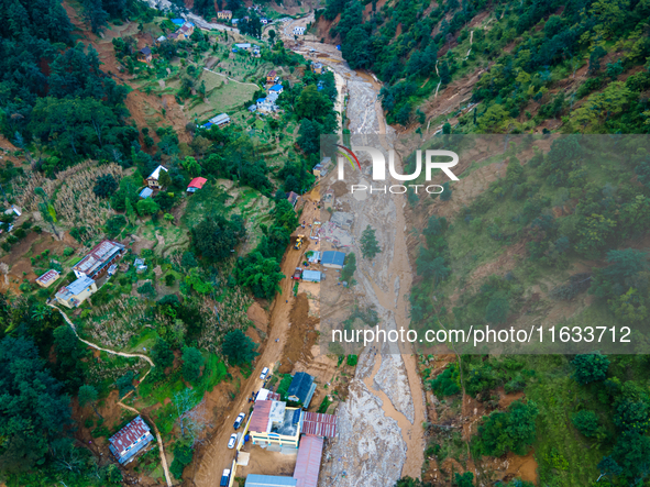 The aerial view shows the flood-affected areas of Patikharka, Kavrepalanchok District, Nepal, on October 3, 2024. Homes are severely damaged...