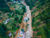 The aerial view shows the flood-affected areas of Patikharka, Kavrepalanchok District, Nepal, on October 3, 2024. Homes are severely damaged...