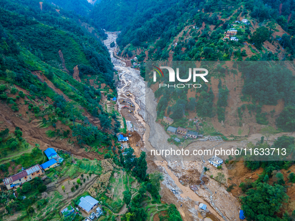 The aerial view shows the flood-affected areas of Patikharka, Kavrepalanchok District, Nepal, on October 3, 2024. Homes are severely damaged...