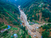 The aerial view shows the flood-affected areas of Patikharka, Kavrepalanchok District, Nepal, on October 3, 2024. Homes are severely damaged...