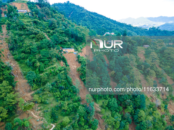 The aerial view shows the flood-affected areas of Patikharka, Kavrepalanchok District, Nepal, on October 3, 2024. Homes are severely damaged...