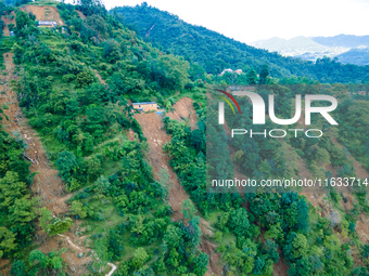 The aerial view shows the flood-affected areas of Patikharka, Kavrepalanchok District, Nepal, on October 3, 2024. Homes are severely damaged...