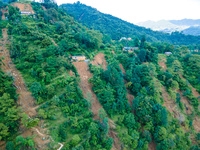 The aerial view shows the flood-affected areas of Patikharka, Kavrepalanchok District, Nepal, on October 3, 2024. Homes are severely damaged...