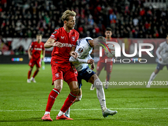 FC Twente midfielder Michel Vlap and Fenerbahce midfielder Sebastian Szymanski play during the match between Twente and Fenerbahce at the Gr...