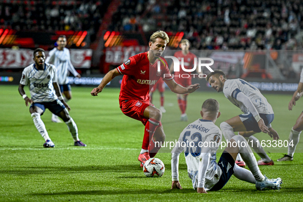 FC Twente midfielder Michel Vlap, Fenerbahce forward Dusan Tadic, and Fenerbahce midfielder Sebastian Szymanski participate during the match...