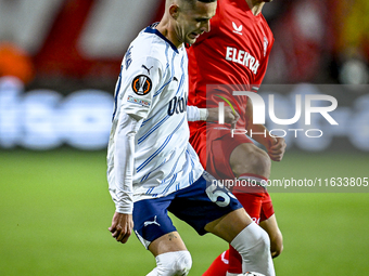 Fenerbahce midfielder Sebastian Szymanski and FC Twente midfielder Youri Regeer play during the match between Twente and Fenerbahce at the G...