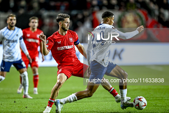 FC Twente forward Ricky van Wolfswinkel and Fenerbahce defender Jayden Oosterwolde play during the match between Twente and Fenerbahce at th...