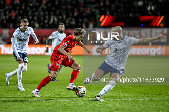 FC Twente midfielder Youri Regeer and Fenerbahce midfielder Sofyan Amrabat play during the match between Twente and Fenerbahce at the Grolsc...