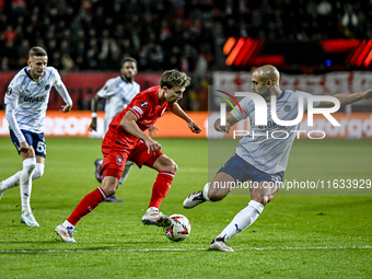 FC Twente midfielder Youri Regeer and Fenerbahce midfielder Sofyan Amrabat play during the match between Twente and Fenerbahce at the Grolsc...