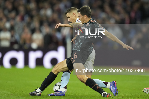 Joao Palhinha defensive midfield of Bayern Munich and Portugal and Lucas Digne left-back of Aston Villa and France compete for the ball duri...