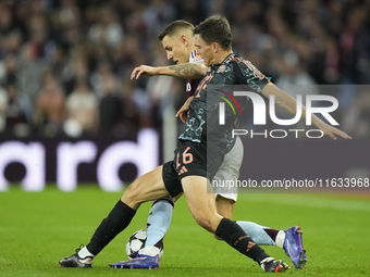 Joao Palhinha defensive midfield of Bayern Munich and Portugal and Lucas Digne left-back of Aston Villa and France compete for the ball duri...