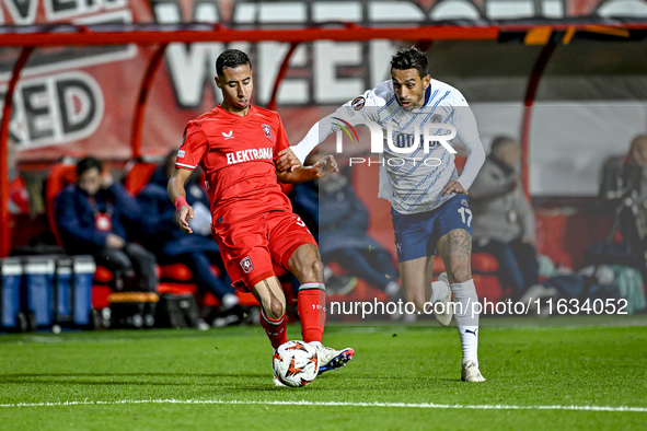 FC Twente defender Anass Salah-Eddine and Fenerbahce midfielder Irfan Can Kahveci play during the match between Twente and Fenerbahce at the...