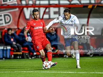 FC Twente defender Anass Salah-Eddine and Fenerbahce midfielder Irfan Can Kahveci play during the match between Twente and Fenerbahce at the...