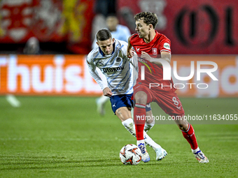 Fenerbahce midfielder Sebastian Szymanski and FC Twente midfielder Youri Regeer play during the match between Twente and Fenerbahce at the G...