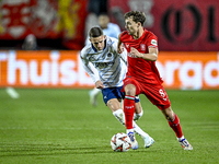 Fenerbahce midfielder Sebastian Szymanski and FC Twente midfielder Youri Regeer play during the match between Twente and Fenerbahce at the G...