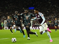 Jaden Philogene left winger of Aston Villa and England and Alphonso Davies left-back of Bayern Munich and Canada compete for the ball during...