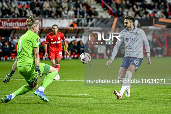 FC Twente goalkeeper Lars Unnerstall and Fenerbahce forward Dusan Tadic score to make it 1-1 during the match between Twente and Fenerbahce...