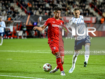 FC Twente defender Mees Hilgers and Fenerbahce midfielder Sebastian Szymanski play during the match between Twente and Fenerbahce at the Gro...