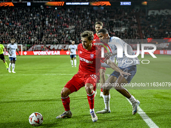 FC Twente defender Bart van Rooij and Fenerbahce defender Jayden Oosterwolde play during the match between Twente and Fenerbahce at the Grol...