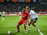 FC Twente defender Bart van Rooij and Fenerbahce defender Jayden Oosterwolde play during the match between Twente and Fenerbahce at the Grol...