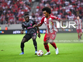 Willian of Olympiacos FC competes with Roger Fernandes of SC Braga during the Europa League, Matchday 2 match between Olympiacos FC and SC B...