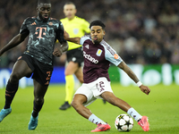 Ian Maatsen left-back of Aston Villa and Netherlands shooting to goal front Dayot Upamecano centre-back of Bayern Munich and France during t...