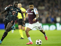 Ian Maatsen left-back of Aston Villa and Netherlands shooting to goal front Dayot Upamecano centre-back of Bayern Munich and France during t...