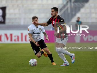 In Ta' Qali, Malta, on October 2, 2024, Jurgen Degabriele of Hibernians follows Juan Carlos Corbalan of Hamrun Spartans during the Malta 360...