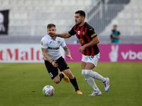 In Ta' Qali, Malta, on October 2, 2024, Jurgen Degabriele of Hibernians follows Juan Carlos Corbalan of Hamrun Spartans during the Malta 360...