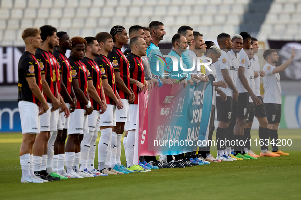 Soccer players from Hamrun Spartans and Floriana stand with the match officials to hold a Marigold Foundation ''Pink October'' Movember camp...