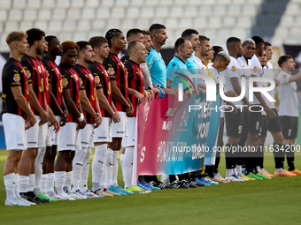 Soccer players from Hamrun Spartans and Floriana stand with the match officials to hold a Marigold Foundation ''Pink October'' Movember camp...