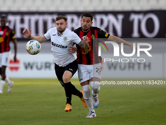 In Ta' Qali, Malta, on October 2, 2024, Jurgen Degabriele of Hibernians is closely challenged by Juan Carlos Corbalan of Hamrun Spartans dur...