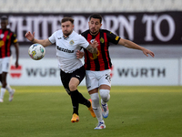 In Ta' Qali, Malta, on October 2, 2024, Jurgen Degabriele of Hibernians is closely challenged by Juan Carlos Corbalan of Hamrun Spartans dur...