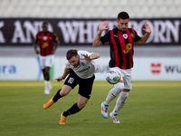 In Ta' Qali, Malta, on October 2, 2024, Jurgen Degabriele of Hibernians is closely challenged by Juan Carlos Corbalan of Hamrun Spartans dur...