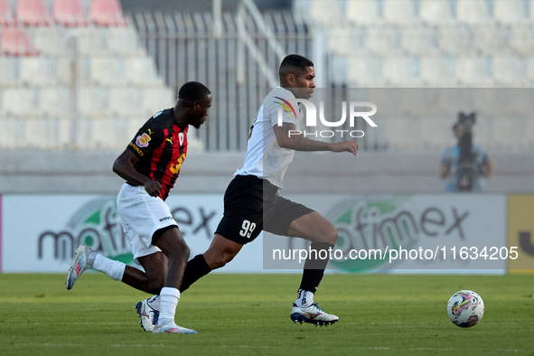 In Ta' Qali, Malta, on October 2, 2024, Higor Gabriel Fernandes Alves of Hibernians is closely followed by Chris Marlon Ondong Ba during the...