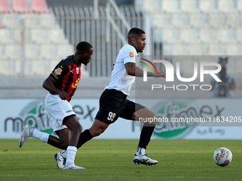 In Ta' Qali, Malta, on October 2, 2024, Higor Gabriel Fernandes Alves of Hibernians is closely followed by Chris Marlon Ondong Ba during the...