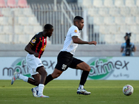 In Ta' Qali, Malta, on October 2, 2024, Higor Gabriel Fernandes Alves of Hibernians is closely followed by Chris Marlon Ondong Ba during the...