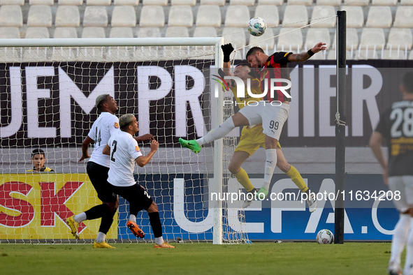 In Ta' Qali, Malta, on October 2, 2024, Hugo Sacco, the goalkeeper of Hibernians, competes for the ball with Silva Lopes Raphael of Hamrun S...