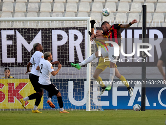 In Ta' Qali, Malta, on October 2, 2024, Hugo Sacco, the goalkeeper of Hibernians, competes for the ball with Silva Lopes Raphael of Hamrun S...