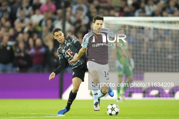 Pau Torres centre-back of Aston Villa and Spain and Jamal Musiala attacking midfield of Bayern Munich and Germany compete for the ball durin...