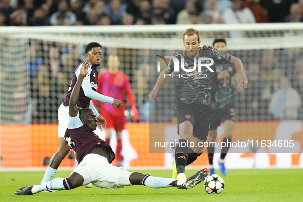 Harry Kane centre-forward of Bayern Munich and England and Amadou Onana defensive midfield of Aston Villa and Belgium compete for the ball d...