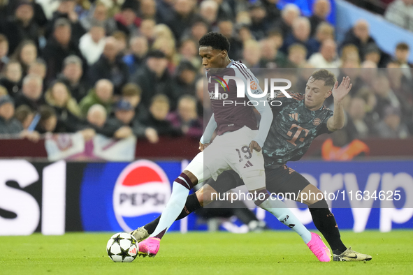 Jaden Philogene left winger of Aston Villa and England and Joshua Kimmich central midfield of Bayern Munich and Germany compete for the ball...