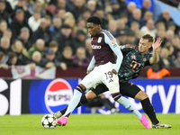 Jaden Philogene left winger of Aston Villa and England and Joshua Kimmich central midfield of Bayern Munich and Germany compete for the ball...