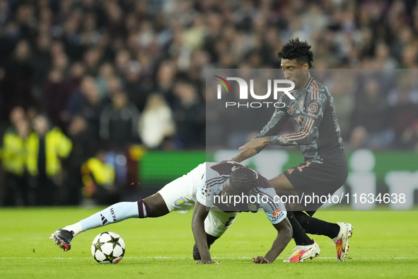 Amadou Onana defensive midfield of Aston Villa and Belgium and Kingsley Coman left winger of Bayern Munich and France compete for the ball d...