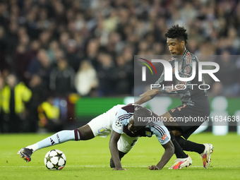 Amadou Onana defensive midfield of Aston Villa and Belgium and Kingsley Coman left winger of Bayern Munich and France compete for the ball d...