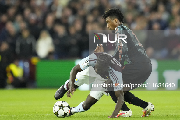 Amadou Onana defensive midfield of Aston Villa and Belgium and Kingsley Coman left winger of Bayern Munich and France compete for the ball d...