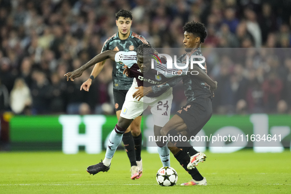 Amadou Onana defensive midfield of Aston Villa and Belgium and Kingsley Coman left winger of Bayern Munich and France compete for the ball d...