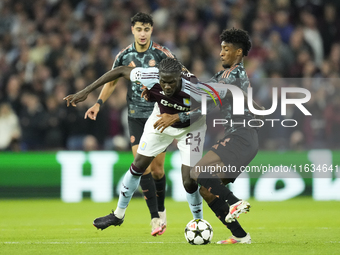 Amadou Onana defensive midfield of Aston Villa and Belgium and Kingsley Coman left winger of Bayern Munich and France compete for the ball d...