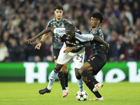 Amadou Onana defensive midfield of Aston Villa and Belgium and Kingsley Coman left winger of Bayern Munich and France compete for the ball d...